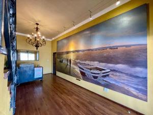 a room with a painting of a boat on the wall at The Sunset Villas in Velddrif