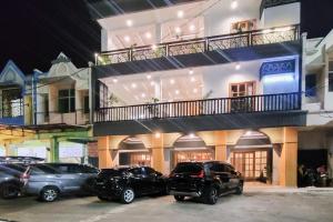 a group of cars parked in front of a building at Urbanview Hotel Bonetta Lampung by RedDoorz in Kedaton