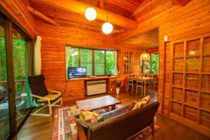 a living room with a couch and a table at 花の街660 Tsumagoi Private House with Parking & BBQ in Tsumagoi