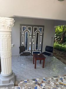 a room with chairs and a table and a column at My Dream in Manduar