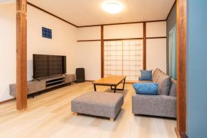 下田市にあるNODE Shimodaのソファとテレビのあるリビングルーム