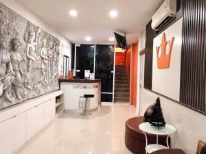 Una sala de estar con un cuadro grande en la pared. en The Loom Rangsit, en Ban Lam Phak Kut