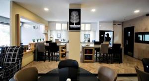 a dining room and kitchen with a table and chairs at Traders Inn Brunei in Kampong Mata Mata