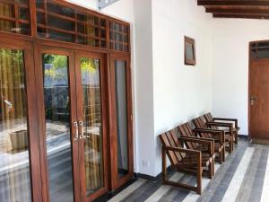 a group of chairs sitting next to a building at Relax Villa Koggala in Habaraduwa