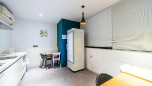 a kitchen with a refrigerator and a table at NU Hotel in Cheonan +39 photos