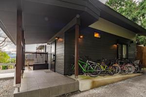 a group of bikes parked on the side of a house at Hakone Villa with your private hot spring! in Hakone
