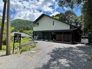 a building with a car parked in front of it at Hakone Villa with your private hot spring! in Hakone