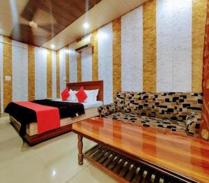 a bedroom with a bed and a couch at hotel grand in Zirakpur