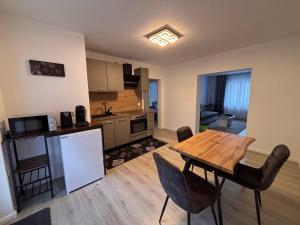 a kitchen and living room with a wooden table and chairs at Ferienwohnung Daviana in Beckingen