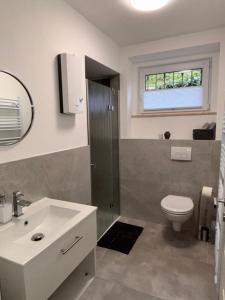 a bathroom with a toilet and a sink at Ferienwohnung Daviana in Beckingen +15 photos