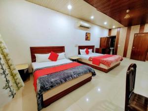 a bedroom with two beds in a room at hotel grand in Zirakpur