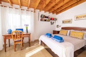 a bedroom with a bed and a desk at Villa La Maja Beachfront in Corralejo