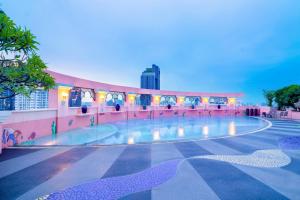 a building with a swimming pool in front of it at Baiyoke Sky Hotel in Bangkok