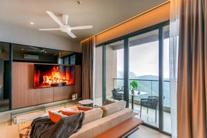 a living room with a couch and a fireplace at Antara Genting Highlands by COBNB - near Link Bridge in Genting Highlands