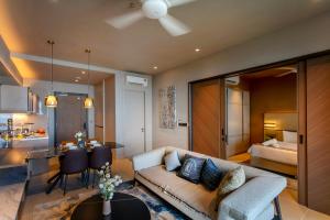 a living room with a couch and a dining room at Antara Genting Highlands by COBNB - near Link Bridge in Genting Highlands