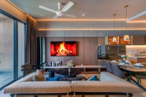 a living room with a fire in the fireplace at Antara Genting Highlands by COBNB - near Link Bridge in Genting Highlands