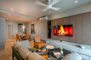 a living room with a fire on the wall at Antara Genting Highlands by COBNB - near Link Bridge in Genting Highlands