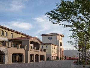a building with a clock tower on top of it at Qiandao Lake CBS Beer Spa Hotel in Thousand Island Lake