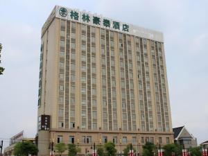 a large building with a clock on top of it at GreenTree Inn Shanghai Jiading Newtown MaLu Subway Station Business Hotel in Jiading
