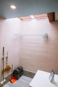 a room with a white wall with a table and trash cans at JZ Homestay - Cozy Home near SM Savemore, Caraga State University & BMC Hospital in Butuan +3 photos