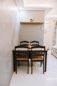 a dining room with three chairs and a table at JZ Homestay - Cozy Home near SM Savemore, Caraga State University & BMC Hospital in Butuan