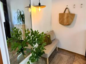 a living room with a bench and a purse at EifelZeit 1 in Kall +16 photos