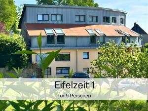a house with solar panels on the side of it at EifelZeit 1 in Kall