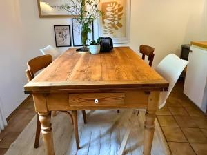 a wooden table in a kitchen with chairs around it at EifelZeit 1 in Kall