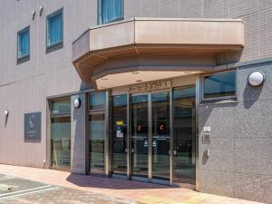 a building with glass doors in front of it at Comfort Hotel Tendo in Tendo