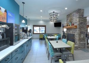 a restaurant with a table and chairs and a kitchen at Brookstone Lodge near Biltmore Village, an Ascend Collection Hotel in Asheville