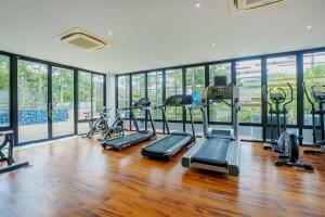 a gym with several treadmills and elliptical machines at 405 Relife , 5 Minutes Walk To Nai Harn Beach in Rawai Beach