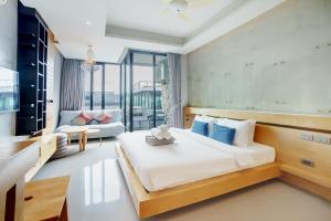a bedroom with a bed and a living room at 405 Relife , 5 Minutes Walk To Nai Harn Beach in Rawai Beach +41 photos
