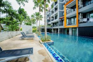 a swimming pool in front of a building at 405 Relife , 5 Minutes Walk To Nai Harn Beach in Rawai Beach