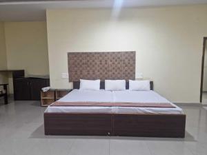 a bedroom with a large bed in a room at - Hotel O Machilipatnam Railway Station Formerly Hasini Celebrations in Machilīpatnam