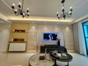 a living room with a television and a table at Shanghai Hongmin Inn in Shanghai