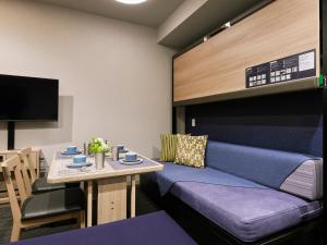 TV a/nebo společenská místnost v ubytování Minn Nishi Kasai