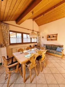 a dining room with a wooden table and chairs at FeWo Honstein in Pfronten