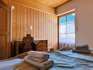 a bedroom with a bed and a desk and a window at FeWo Honstein in Pfronten +26 photos
