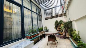 a room with a table and some potted plants at Welcome to your home away from home! in Kabul
