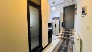 a hallway with two black doors and a hallway with stairs at Welcome to your home away from home! in Kabul