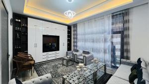 a living room with a television and a table at Welcome to your home away from home! in Kabul