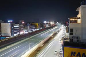 a city street at night with buildings and street lights at Hotel Galaxy Park in Shamshabad +14 photos
