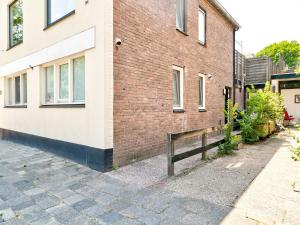 a wooden bench next to a brick building at Stunning apartment in Schoorl, North Hollandâ you can bike to the beach in Schoorl