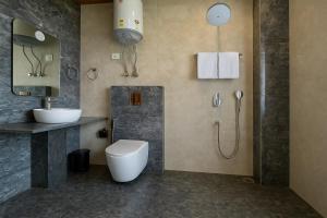 a bathroom with a toilet and a sink and a shower at The Manali Suits & Villa - Luxury Stay Away From City Hustle in Manāli +45 photos