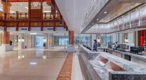 a large kitchen in a building with people in it at Wudangshan Jianguo Hotel in Liuliping