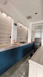 a kitchen with blue cabinets and a counter top at Villa Dalia Puncak NA6-12 in Cimacan