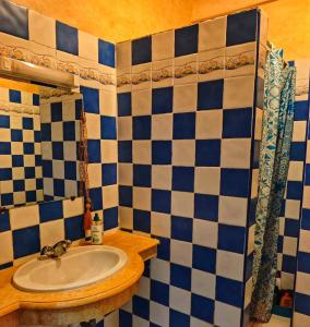 a bathroom with a sink and blue and white tiles at Ocean Hideaway - Sea View in Essaouira
