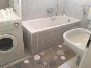 a bathroom with a tub and a toilet and a sink at Apartment Satus in Podstrana +40 photos
