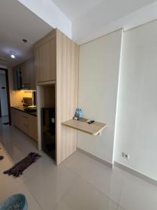 a kitchen with a counter in the corner of a room at Pollux Habibie Deluxe 3 City View lt 28 by Superstay in Batam Center +1 photo