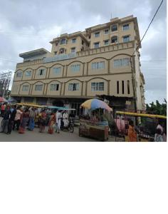 a large building with people standing in front of it at 2 Bedroom furnished flat in Iskcon Mayapur in mayapur